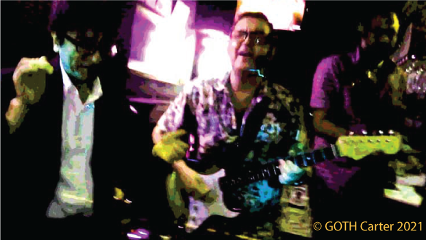 GOTH Carter live performance photo with business men and others dancing wildly.